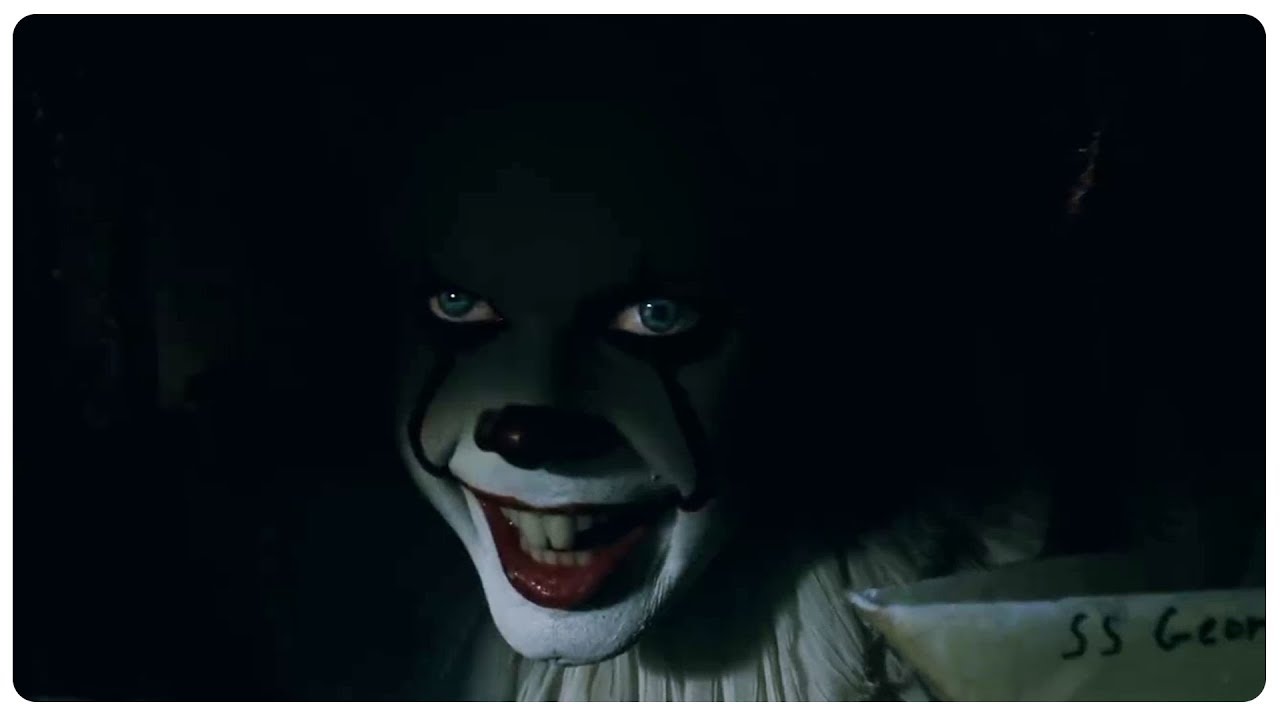  Pennywise looks out from the sewer with hungry, menacing eyes. (It, 2017)