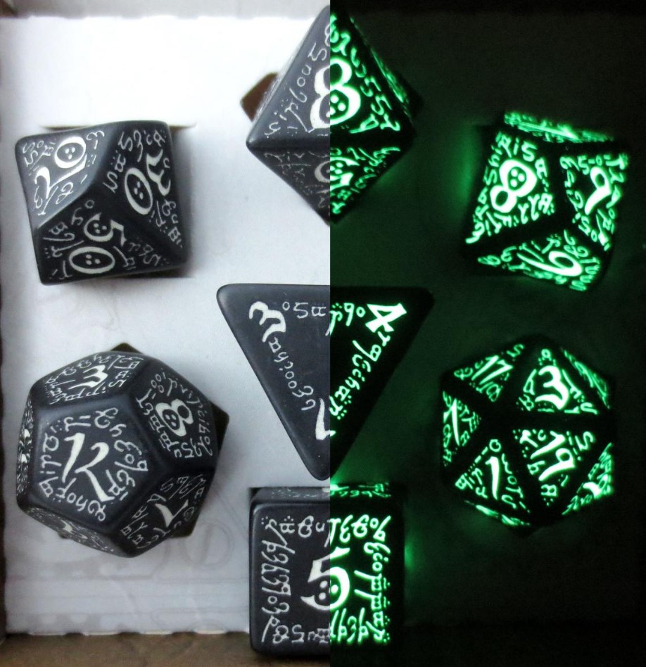 Imagine the One Ring from Lord of the Rings engraved in obsidian, and glows green in the dark. That's an idea of what these dice look like. The numbers are pretty much the same style.