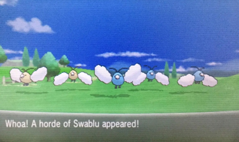 A flock of wild Swablu, including two shinies, attack the main character in a Horde Battle