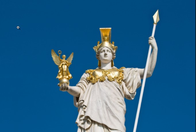 A picture of a statue of Athena, she has a spear in one hand and a smaller winged statue in the other.